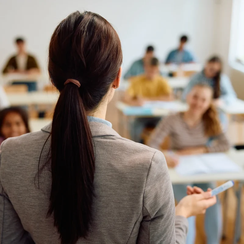 rear-view-of-professor-teaching-her-students-in-th-2024-12-13-18-35-39-utc